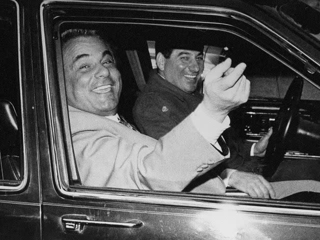 <p>NY Daily News Archive/Getty</p> John Gotti at the Ravenite Social Club on Mulberry St., circa 1990.
