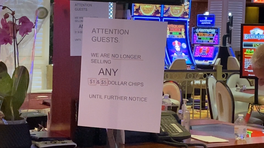 <em>Signs posted at most playing tables inside The Tropicana casino floor acknowledge the cease sale of $1 and $5 chips. (KLAS)</em>