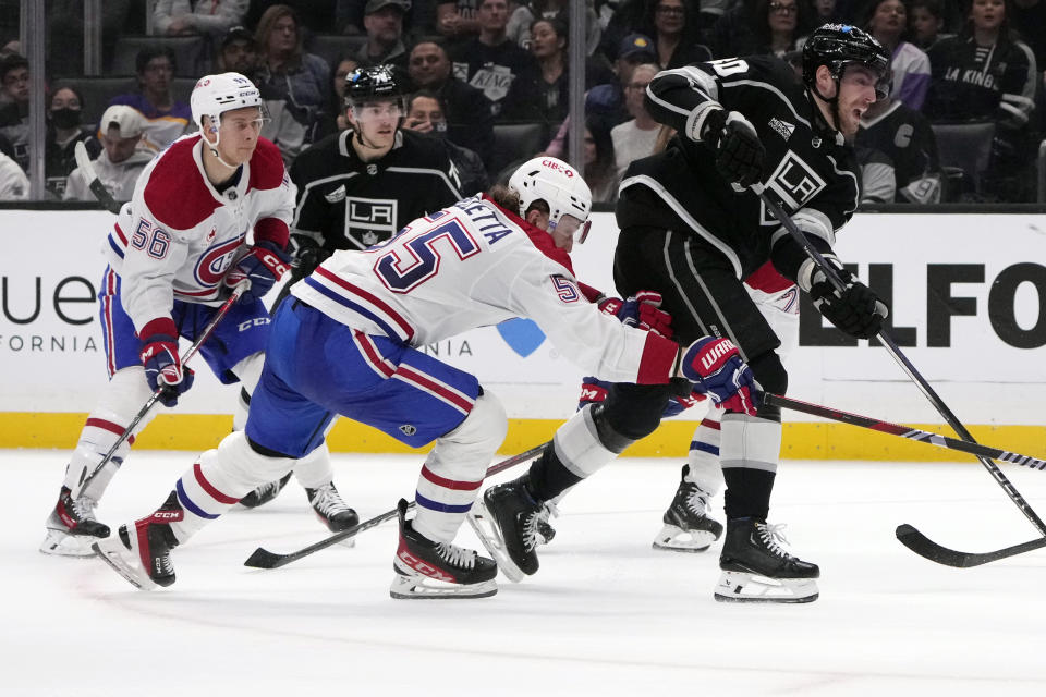 Los Angeles Kings left wing Pierre-Luc Dubois (80), right, shoots as Montreal Canadiens left wing Michael Pezzetta (55) defends during the second period of an NHL hockey game Saturday, Nov. 25, 2023, in Los Angeles. (AP Photo/Marcio Jose Sanchez)