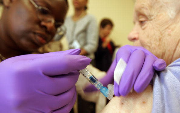 NEW YORK – Senior citizen Mary Lenihan is administered a free flu shot at New York-Presyterian Hospital’s Allen Pavilion (Mario Tama/Getty Images)