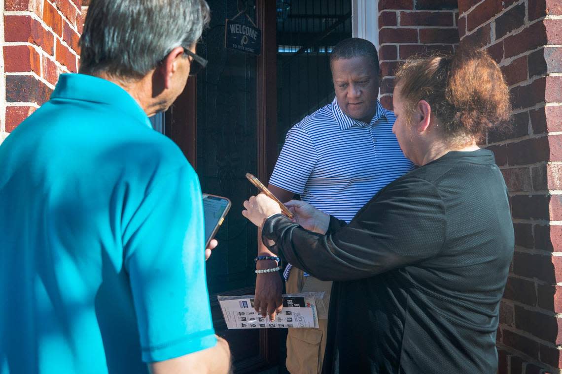 Derrick McGolthian chats with Nadia and Amjad Bhular as the couple canvasses their neighborhood for Democratic campaigns in Grand Prairie, Texas, on Wednesday, Oct. 5, 2022. Ahead of the midterm elections, the Bhulars feel it’s essential to spread the message not just for the gubernatorial race, but also local candidates.