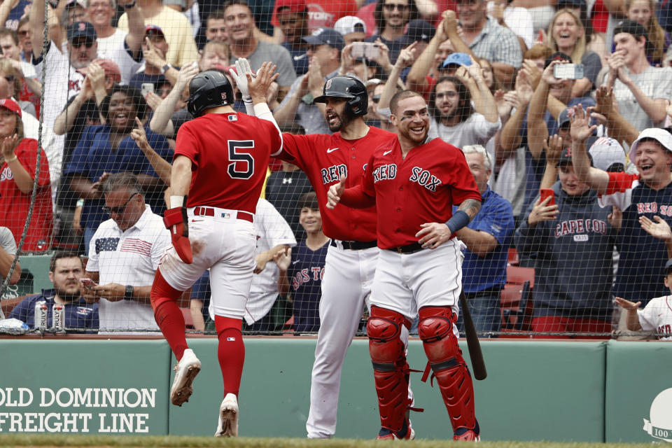Enrique Hernandez (5) of the Boston Red Sox celebrates with J.D. Martinez, center, and catcher Christian Vazquez after scoring the go-ahead run against the Yankees on Sunday. (Photo By Winslow Townson/Getty Images)