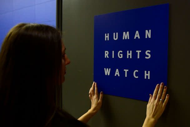 PHOTO: A woman puts a logo of US-based rights group Human Rights Watch on the door as she prepares the room before their press conference to release their annual World report, Jan. 21, 2014, in Berlin. (John Macdougall/AFP via Getty Images)