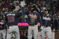 Atlanta Braves' Travis d'Arnaud, left, is congratulated by Dansby Swanson after hitting a three-run home run that scored Adam Duvall, right, and Austin Riley during the ninth inning of the team's baseball game against the San Francisco Giants in San Francisco, Friday, Sept. 17, 2021. (AP Photo/Jeff Chiu)