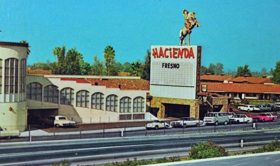 A postcard from the 1960s of the Fresno Hacienda Motel, with the sign of the vaquero waving to passing Highway 99 motorists.