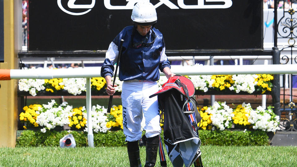 Ryan Moore walks back to mounting yard. (Photo by Vince Caligiuri/Getty Images)