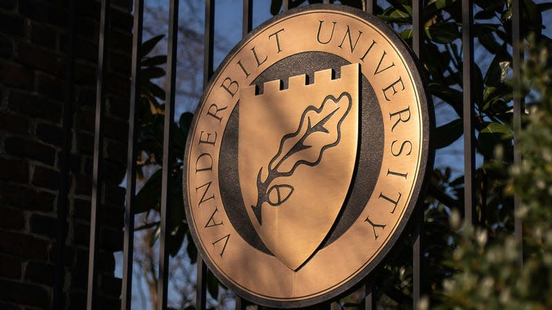A photo of a gold Vanderbilt University plaque on a gate.