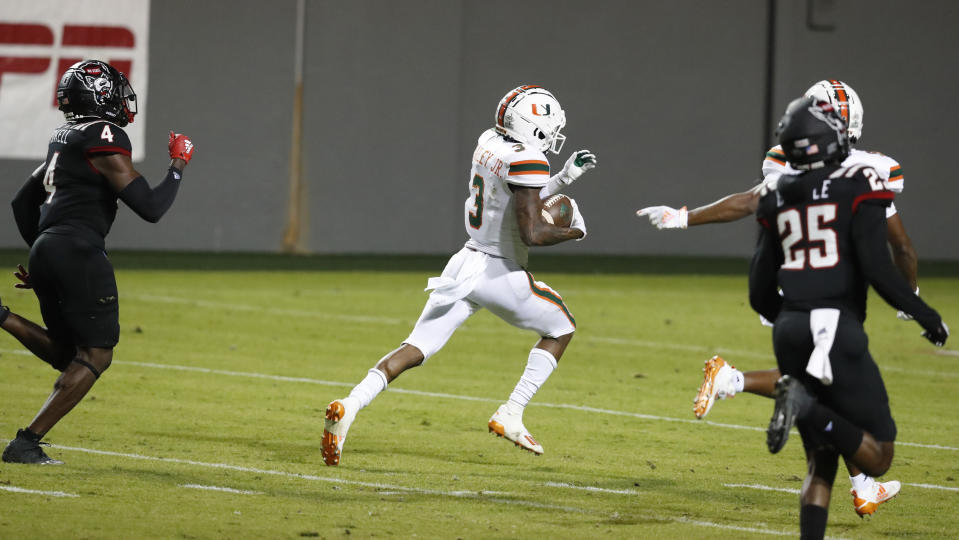 Miami wide receiver Mike Harley (3) runs on a 54-yard touchdown reception as North Carolina State cornerback Cecil Powell (4) trails during the second half of an NCAA college football game Friday, Nov. 6, 2020, in Raleigh, N.C. (Ethan Hyman/The News & Observer via AP, Pool)