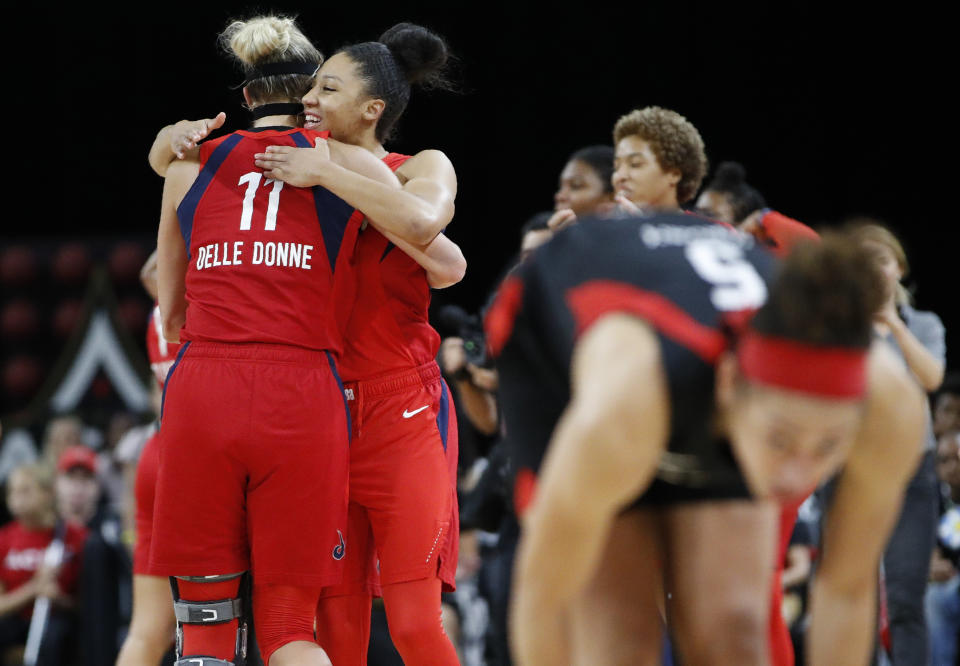 Washington Mystics' Elena Delle Donne, left, and Aerial Powers celebrate after defeating the Las Vegas Aces in Game 4 of a WNBA playoff basketball series Tuesday, Sept. 24, 2019, in Las Vegas. (AP Photo/John Locher)