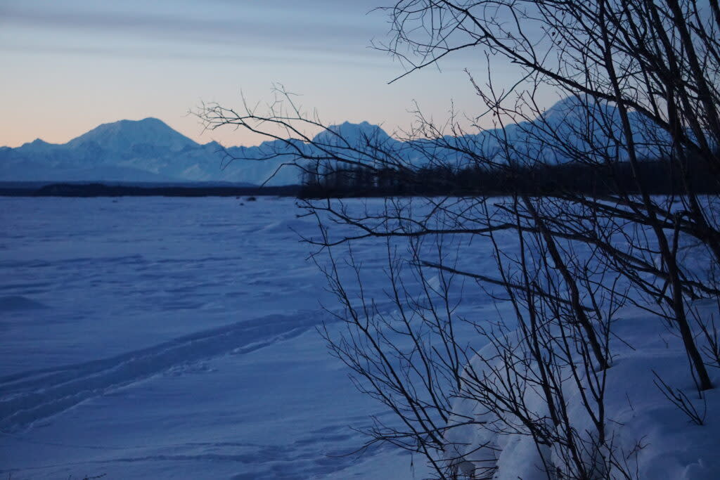 From right to left, Denali, Mount Hunter and Mount Foraker are seen from the frozen Talkeetna River on the evening of March 9, 2024. (Photo by Yereth Rosen/Alaska Beacon)