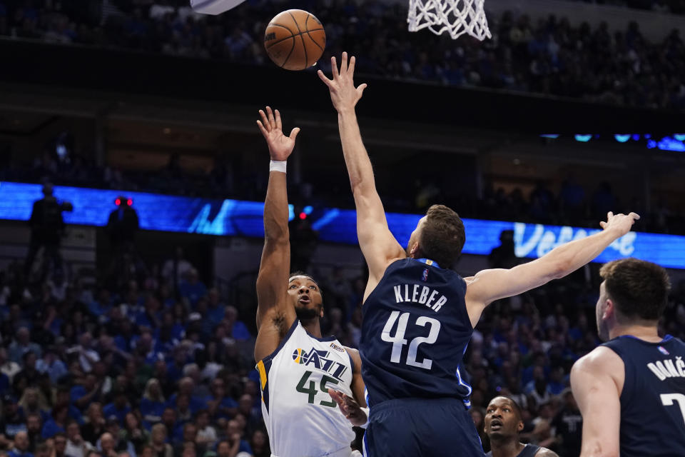 Utah Jazz guard Donovan Mitchell (45) shoots over Dallas Mavericks forward Maxi Kleber (42) during the second half of Game 5 of an NBA basketball first-round playoff series, Monday, April 25, 2022, in Dallas. (AP Photo/Tony Gutierrez)