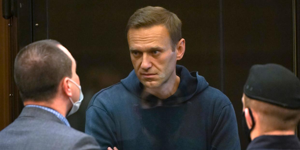 Russian opposition leader Alexei Navalny talks to one of his lawyers