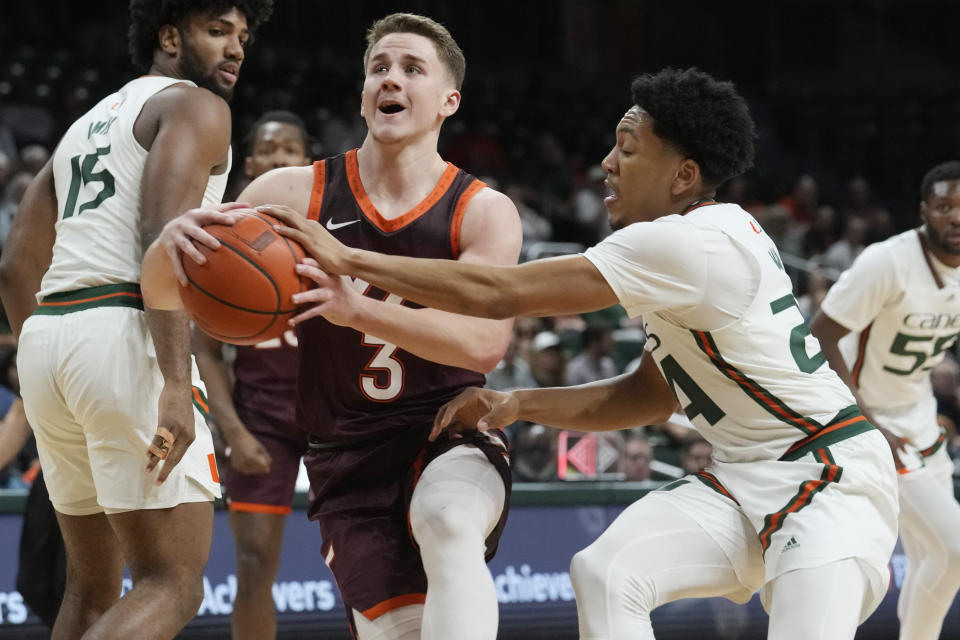 Virginia Tech guard Sean Pedulla (3) drives to the basket as Miami guard Nijel Pack (24) defends during the first half of an NCAA college basketball game, Tuesday, Jan. 31, 2023, in Coral Gables, Fla. (AP Photo/Marta Lavandier)