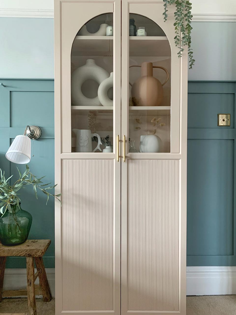 A storage cabinet in a muted tone, with a fluted exterior