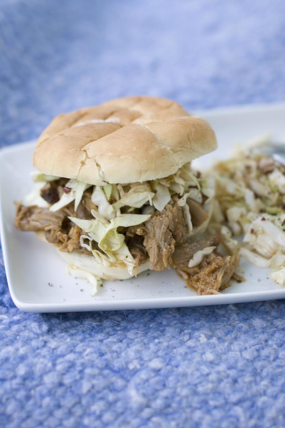 This July 15, 2013 photo shows a North Carolina-style pulled pork sandwich with North Carolina barbecue sauce and coleslaw. (AP Photo/Matthew Mead)