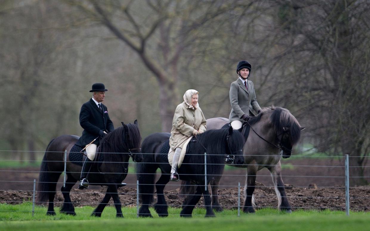 The monarch, 90, was spotted dressed in a beige coat and matching shawl, which she tied round her head, as she rode the small black horse alongside two others - Kelvin Bruce