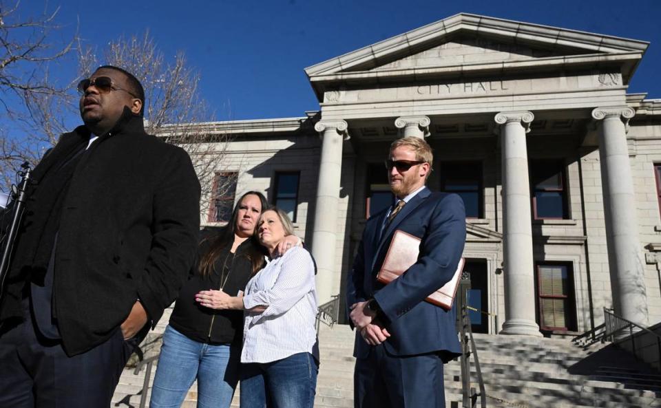 Attorneys Harry Daniels, left, and Kevin Mehr, right, stand as Kevin Dizmang’s daughter, Kenda James, and her mother, Linda Yutzy, hug during a press conference outside City Hall on Tuesday, Feb. 13, 2024, in Colorado Springs, Colo. Jerilee Bennett/The Gazette via AP