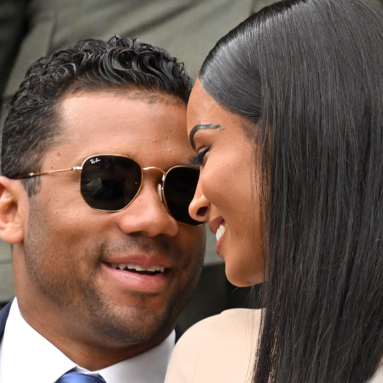  Russell Wilson and Ciara smile at each other. 