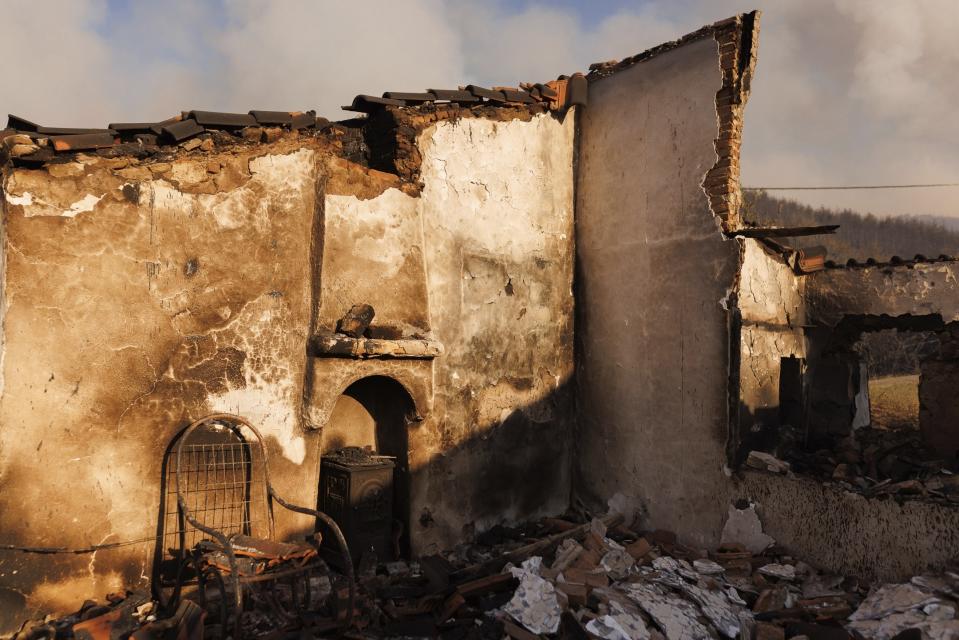 A burnt house stands in the village of Sostis, near Komotini town, in the northeastern Rodopi region, Greece, Tuesday, Aug. 22, 2023. Gale-force winds fanned the flames of wildfires across Greece, including more than four dozen new blazes that broke out Monday amid hot, dry and windy weather that has sucked moisture from vegetation. Two people died and two firefighters were injured, authorities said. (AP Photo/Achilleas Chiras)