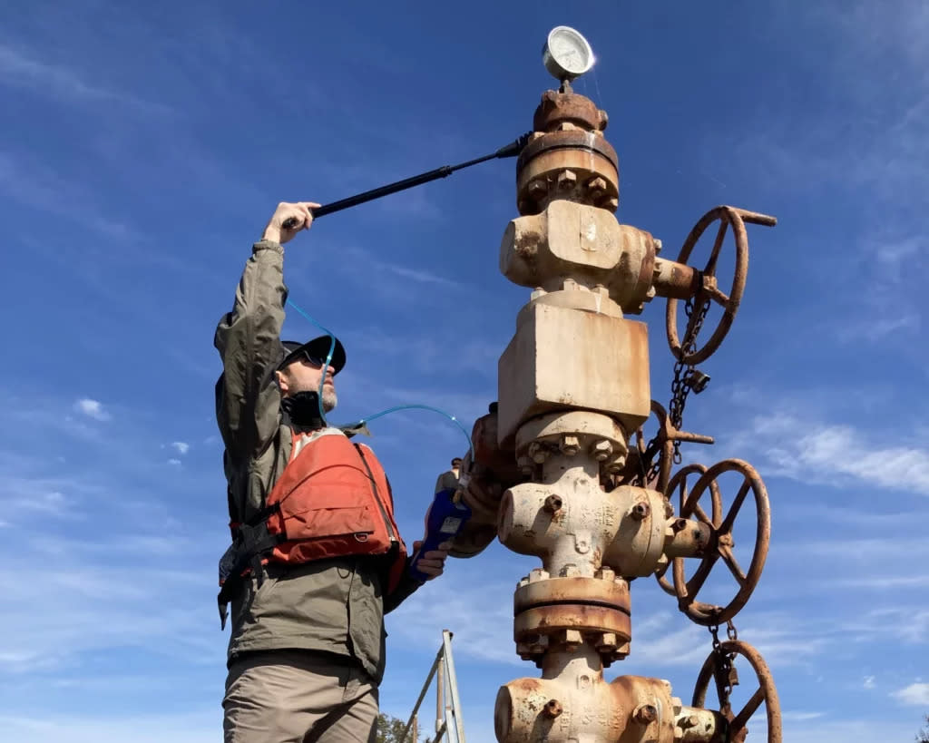 A U.S. Fish and Wildlife Service worker tests an abandoned well in Lacassine National Wildlife Refuge near Lake Charles.