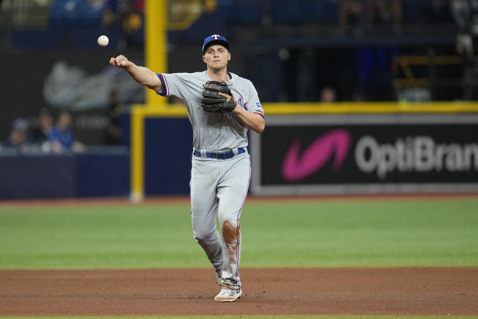 Texas Rangers shortstop Corey Seager throws out Tampa Bay Rays' Harold Ramirez on an infield grounder in the seventh inning during Game 2 in an AL wild-card baseball playoff series, Wednesday, Oct. 4, 2023, in St. Petersburg, Fla. (AP Photo/John Raoux)