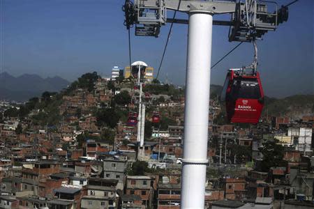Cable cars are seen over Complexo do Alemao slum in Rio de Janeiro March 15, 2014. REUTERS/Pilar Olivares