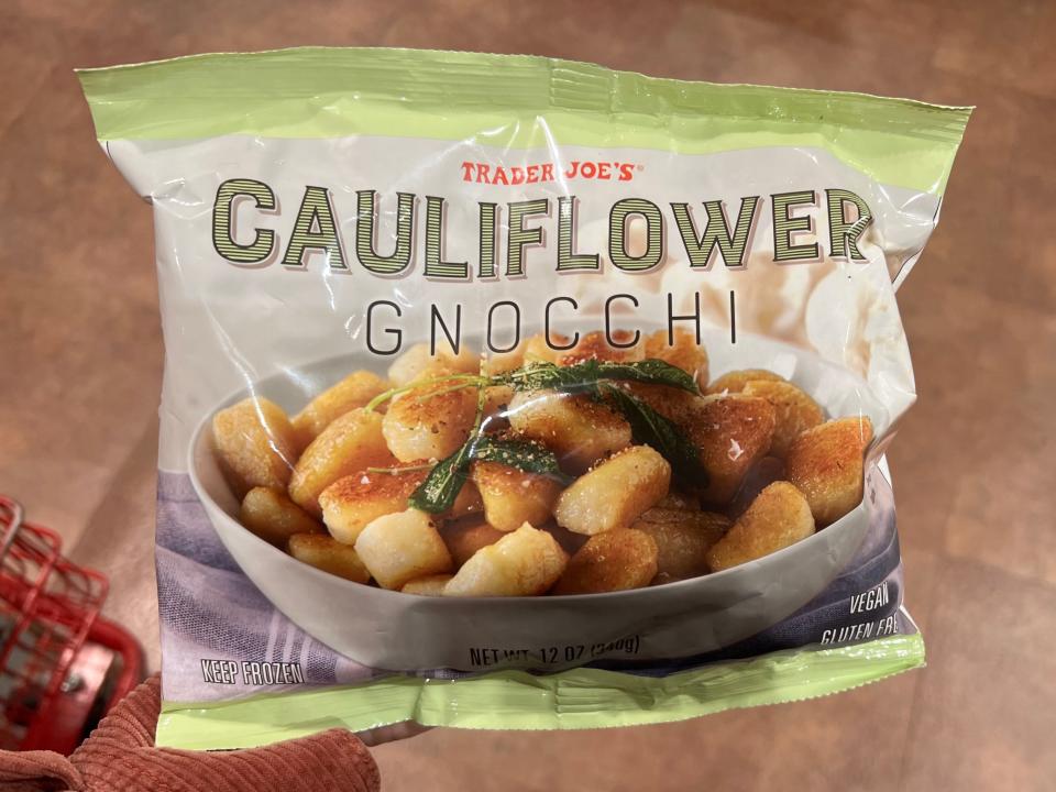The writer holds a bag of Trader Joe's cauliflower gnocchi
