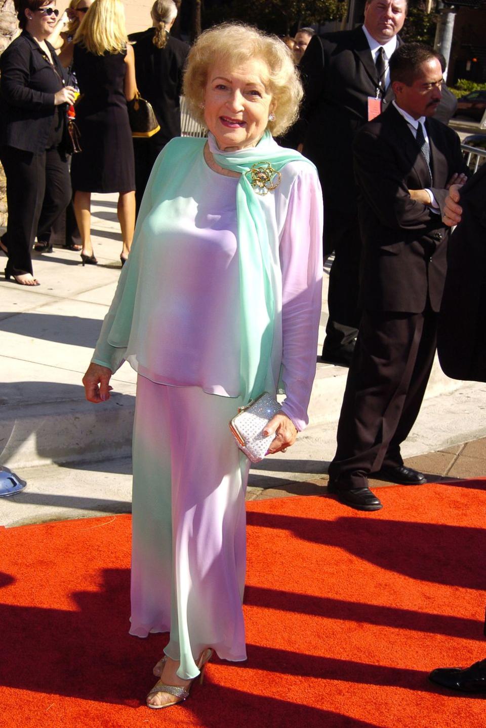 <p>Betty is as beautiful as always, perfectly coiffed and turned out in this sherbet-colored chiffon number (and wearing her favorite recycled silver heels from last year!). </p>