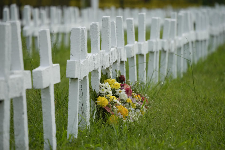 Flowers lay beside crosses at the mass grave site at the Holy Cross Memorial Garden for victims of super Typhoon Haiyan in Tacloban, central Philippines on Sunday Oct. 23, 2022. About 40% of the population of Tacloban were relocated to safer areas after super Typhoon Haiyan wiped out most of the villages, killing thousands when it hit central Philippines on 2013. (AP Photo/Aaron Favila)