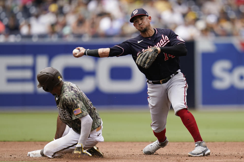 Washington Nationals shortstop Ildemaro Vargas throws to first too late for a double play as San Diego Padres's Jose Azocar slides in late to second base during the third inning of a baseball game Sunday, Aug. 21, 2022, in San Diego. San Diego Padres' Juan Soto was safe at first on the fielder's choice. (AP Photo/Gregory Bull)