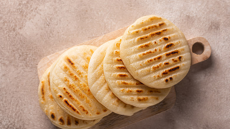 Corn arepas on a board