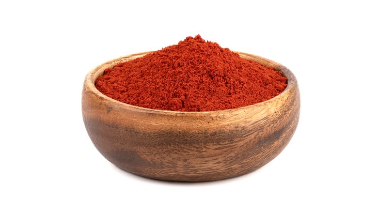 red paprika in wooden bowl