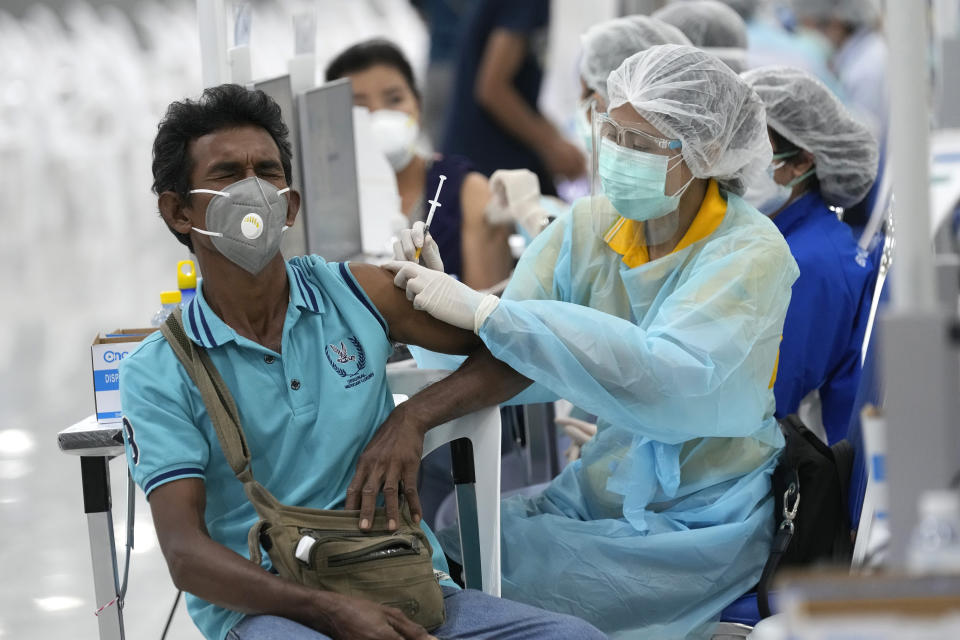 A health worker administers a dose of the AstraZeneca COVID-19 vaccine at the Central Vaccination Center in Bangkok, Thailand, Wednesday, July 14, 2021. Health authorities in Thailand said Wednesday they will seek to put limits on the export of locally produced AstraZeneca vaccine, as the country’s supplies of COVID-19 vaccines are falling short of what is needed for its own population. (AP Photo/Sakchai Lalit)