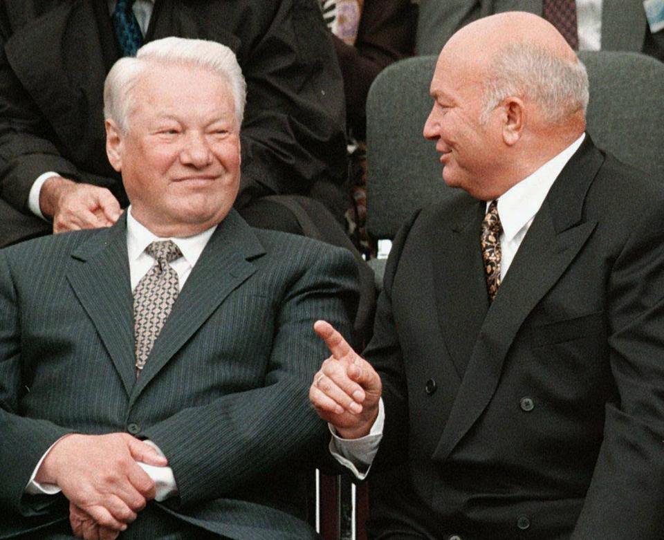 FILE - In this Wednesday, Sept. 2, 1998 file photo, Russian President Boris Yeltsin, left, smiles next to Moscow mayor Yuri Luzhkov during the opening ceremony of a memorial synagogue on Poklonnaya Hill in Moscow. The former mayor of Moscow and one of the founders of Russia's ruling United Russia party, Yuri Luzhkov, has died at the age of 83. Russia's Ren TV channel reported Tuesday Dec. 10, 2019, that Luzhkov died in Munich, where he was undergoing heart surgery. (Sputnik, Kremlin Pool Photo via AP, File)