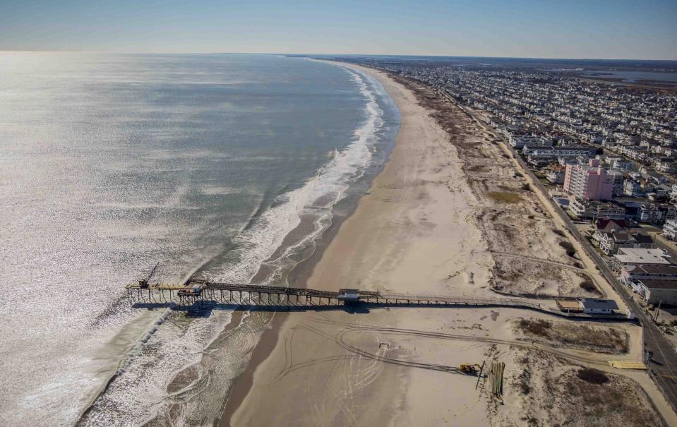 FILE - This Feb. 4, 2021, file photo shows the beach coastline of Ocean City, N.J. A large offshore wind energy project planned off the coast of New Jersey would run cables from the wind farm to potentially three locations, including Ocean City. (AP Photo/Ted Shaffrey, File)