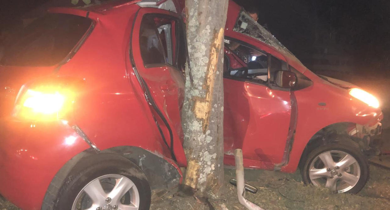 A red Toyota Yaris crashed into a tree in Mudgeeraba