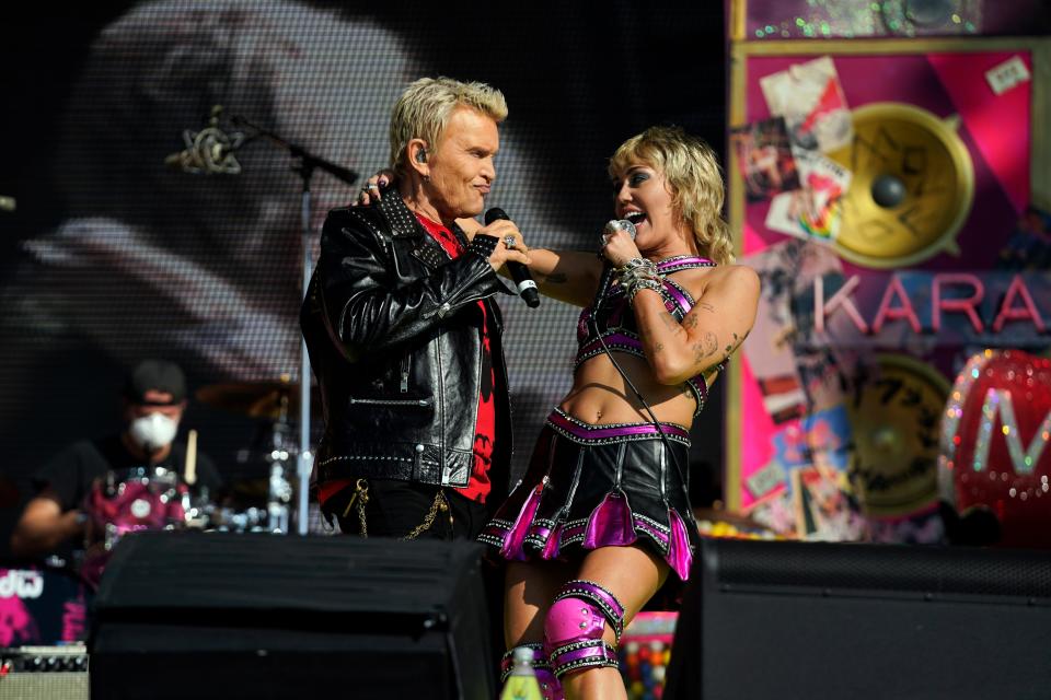 Miley Cyrus, right, and Billy Idol perform before the Kansas City Chiefs play the Tampa Bay Buccaneers in Super Bowl LV.