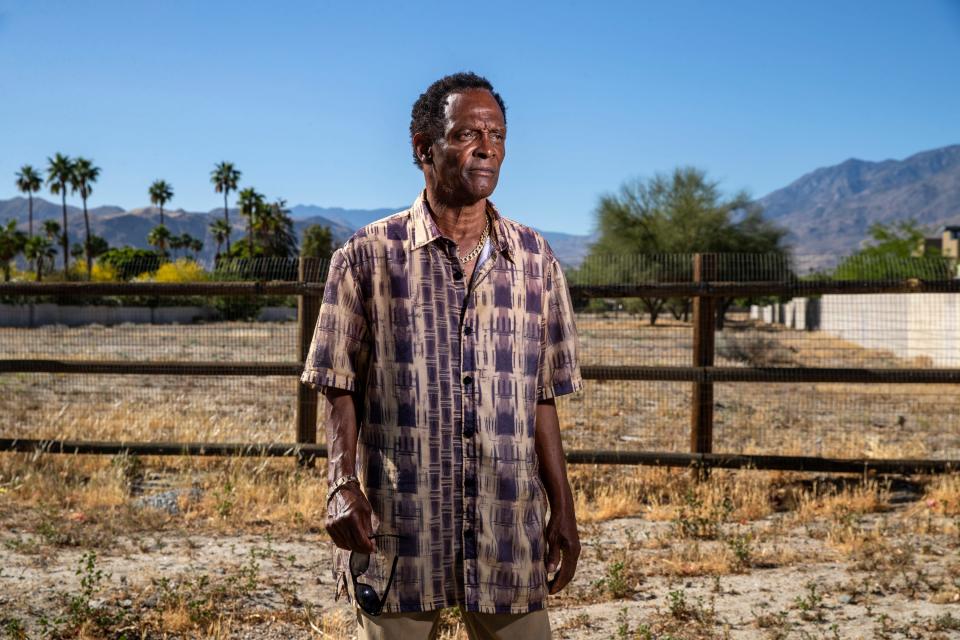 Alvin Taylor stands in front of the Section 14 lot of land where his childhood home used to be near East Arenas Road in Palm Springs.