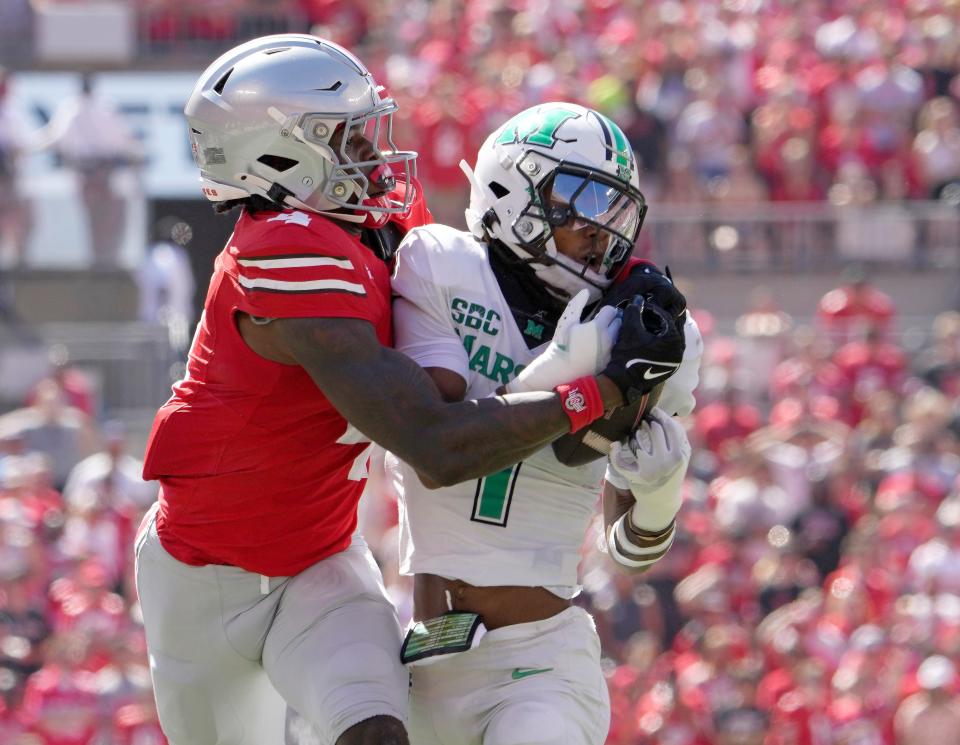 Marshall defensive back Josh Moten intercepts a pass intended for Ohio State wide receiver Jeremiah Smith.