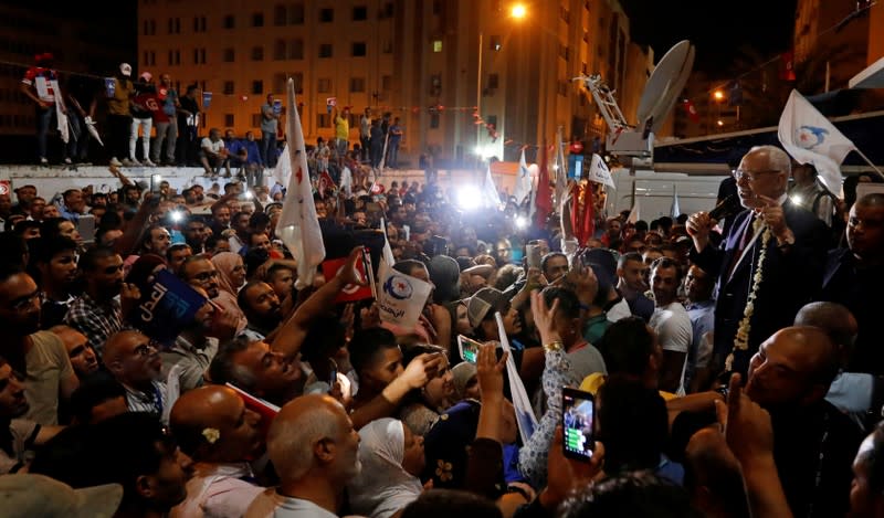 FILE PHOTO: Rached Ghannouchi, leader of Tunisia's moderate Islamist Ennahda, speaks to supporters after the party gained most votes in Sunday's parliamentary election, according to an exit poll by Sigma Conseil broadcasted by state television, in Tunis