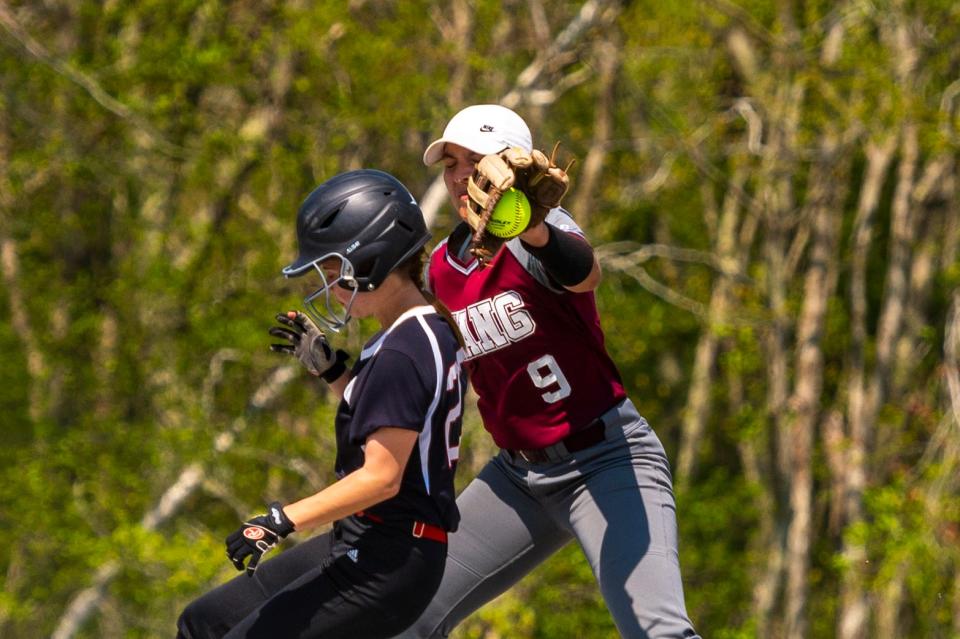 Bishop Stang's Katie Manzone looks to slap the tag on Old Rochester's Emily Kilpatrick.