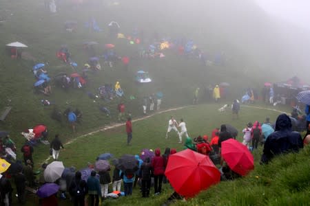 Spectators surround the arena as men fight during the "Hundstoa Ranggeln" at Hundstein mountain near the village of Maria Alm