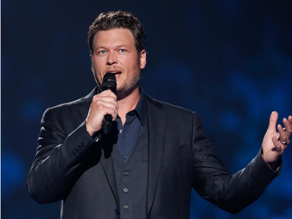 Country singer Blake Shelton speaks into a microphone