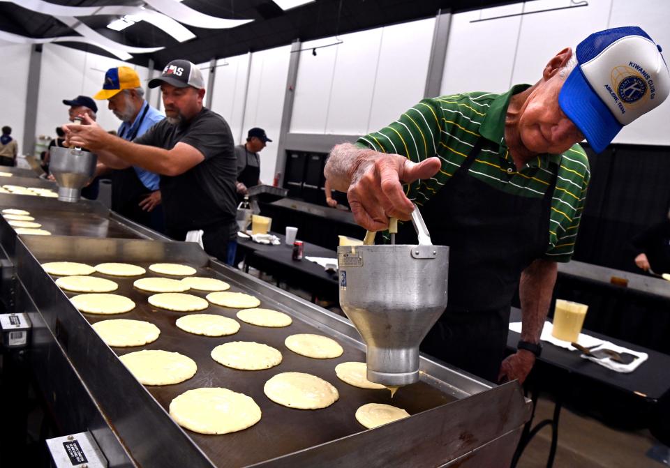 Jeff Goodin loads a griddle up with batter during the Kiwanis Club of Abilene’s Pancake Day at the Abilene Convention Center Saturday.