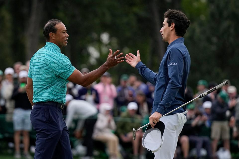 Juaquin Niemann (right) shakes hands with Tiger Woods after their round in the 2022 Masters at the Augusta National Golf Club.