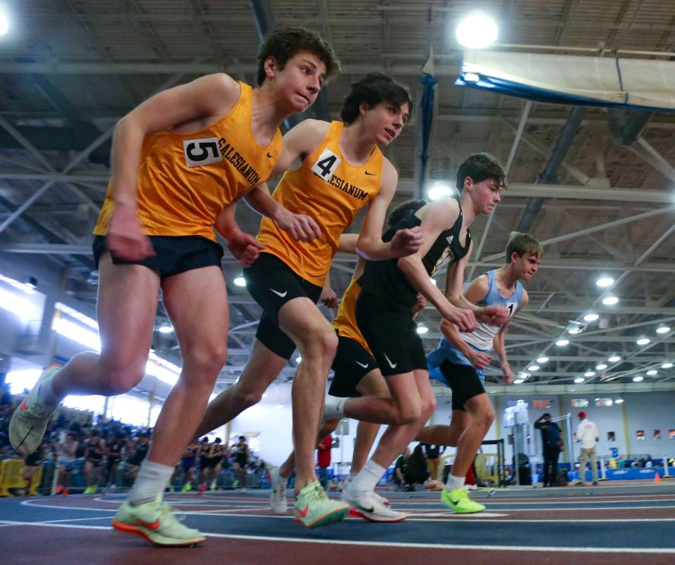 The top-seeded competitors take off at the start of the 3200 meter run during the DIAA state high school indoor track and field championships at Prince George's Sports and Learning Complex in Landover, Md., Saturday, Feb. 4, 2023. Cape Henlopen's Ryan Baker (right) won. Salesianum's Sam Felice (left) and teammate James Kennedy run next to Tatnall's Ben Pizarro, the second-place finisher.