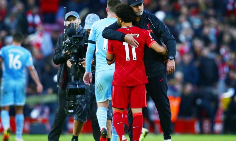 Jurgen Klopp hugs Mohamed Salah after the pulsating draw with Manchester City.