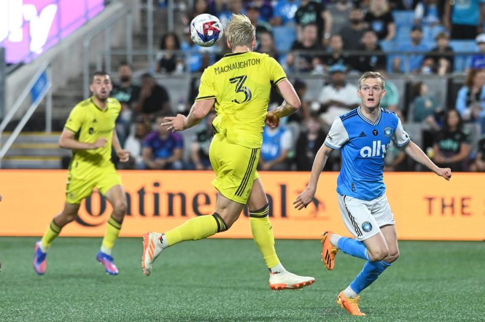 May 20, 2023; Charlotte, North Carolina, USA; Nashville SC defender Lukas MacNaughton (3) heads the ball in front of Charlotte FC attacker Karol Swiderski (11) in the second half at Bank of America Stadium. Mandatory Credit: Griffin Zetterberg-USA TODAY Sports