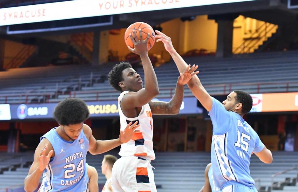 Syracuse Orange forward Kadary Richmond (3) shoots the ball as North Carolina Tar Heels forward Garrison Brooks (15) and guard Kerwin Walton (24) defend in the first half at the Carrier Dome.