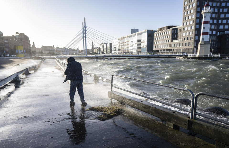 High water levels and waves hit the road in Malmo harbour, Sweden, Sunday Jan. 30, 2022, after a powerful winter storm swept through northern Europe over the weekend. Storm Malik was advancing in the Nordic region on Sunday, bringing strong gusts of wind, and extensive rain and snowfall in Denmark, Finland, Norway and Sweden. (Johan Nilsson/TT via AP)
